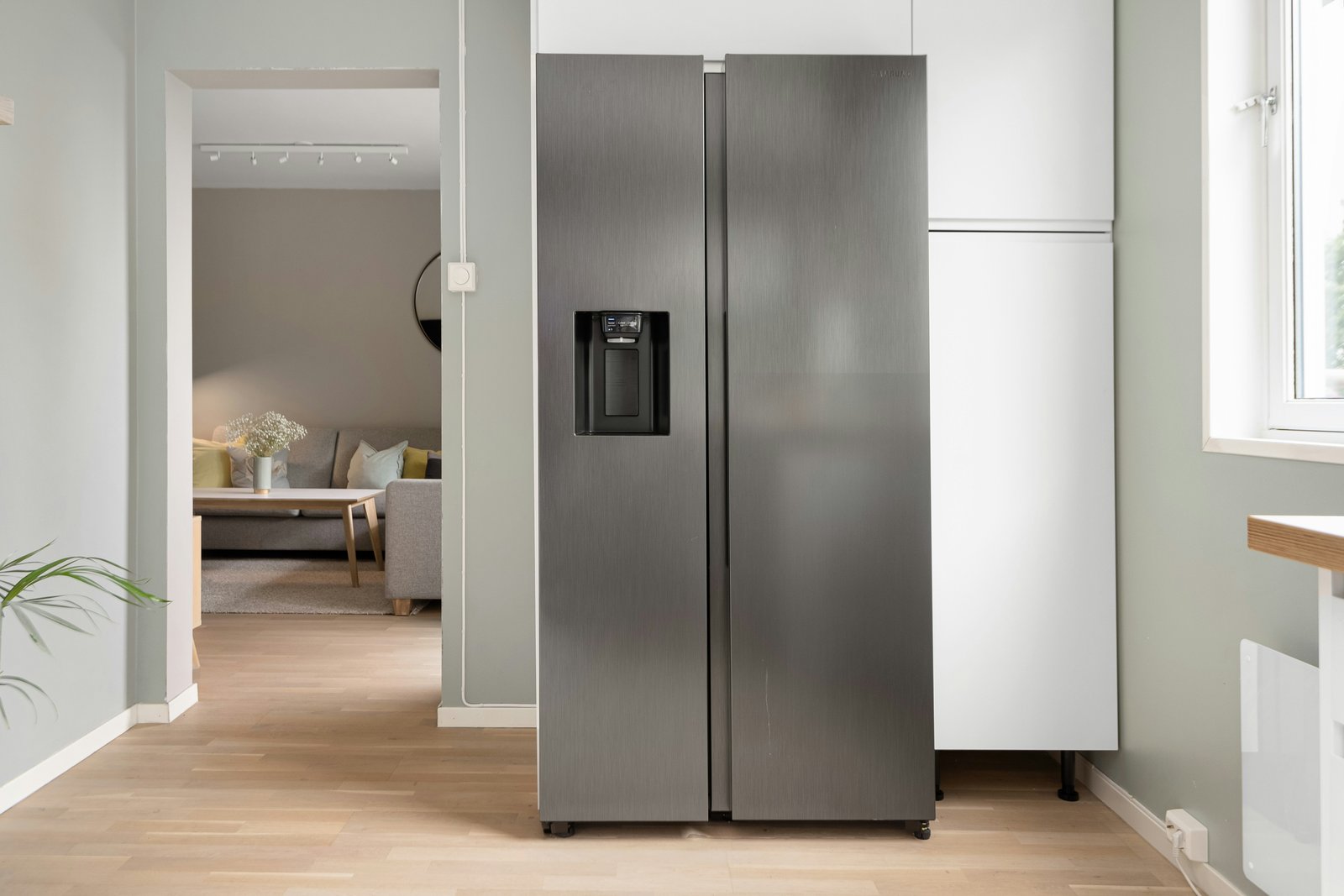 Technician repairing an open refrigerator
